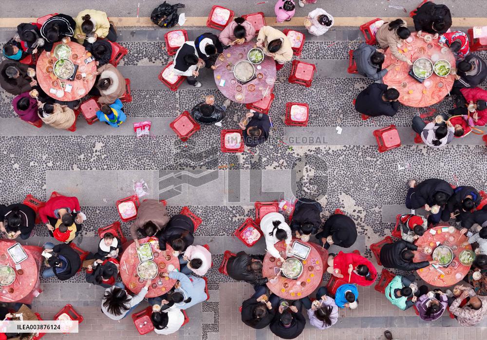 Community Owners Sit Around Tables and Eat Soup