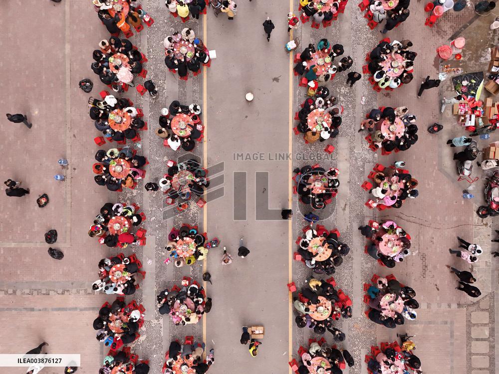 Community Owners Sit Around Tables and Eat Soup