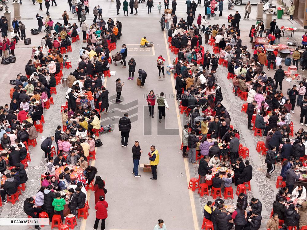 Community Owners Sit Around Tables and Eat Soup