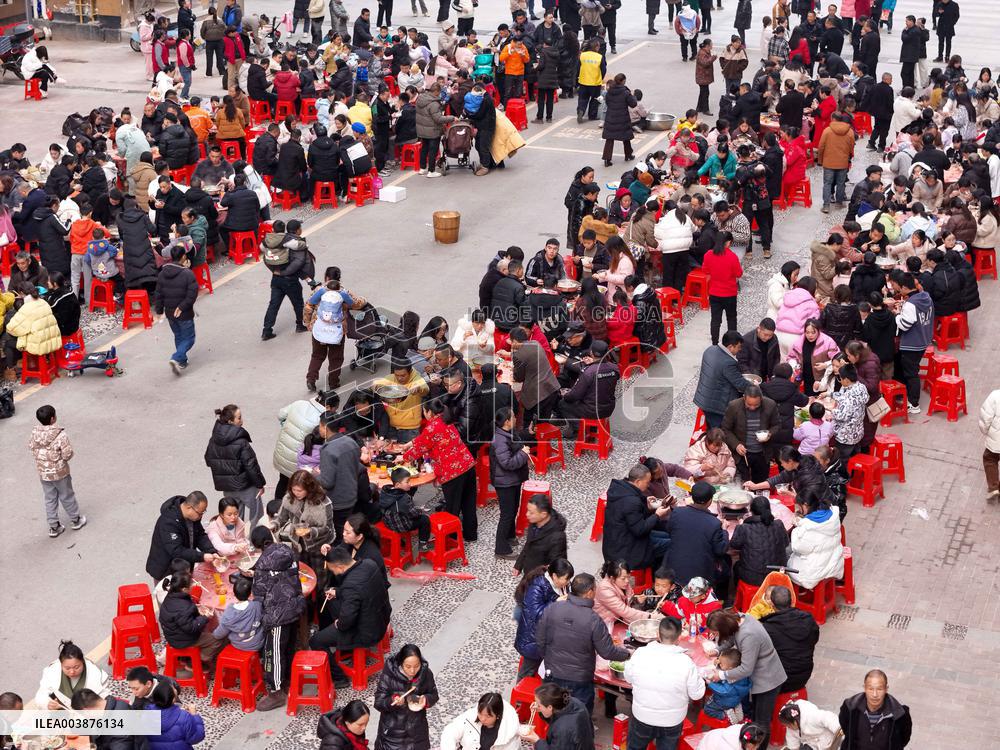 Community Owners Sit Around Tables and Eat Soup