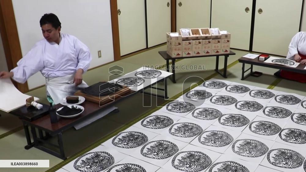 Making of paper charms at Japanese shrine
