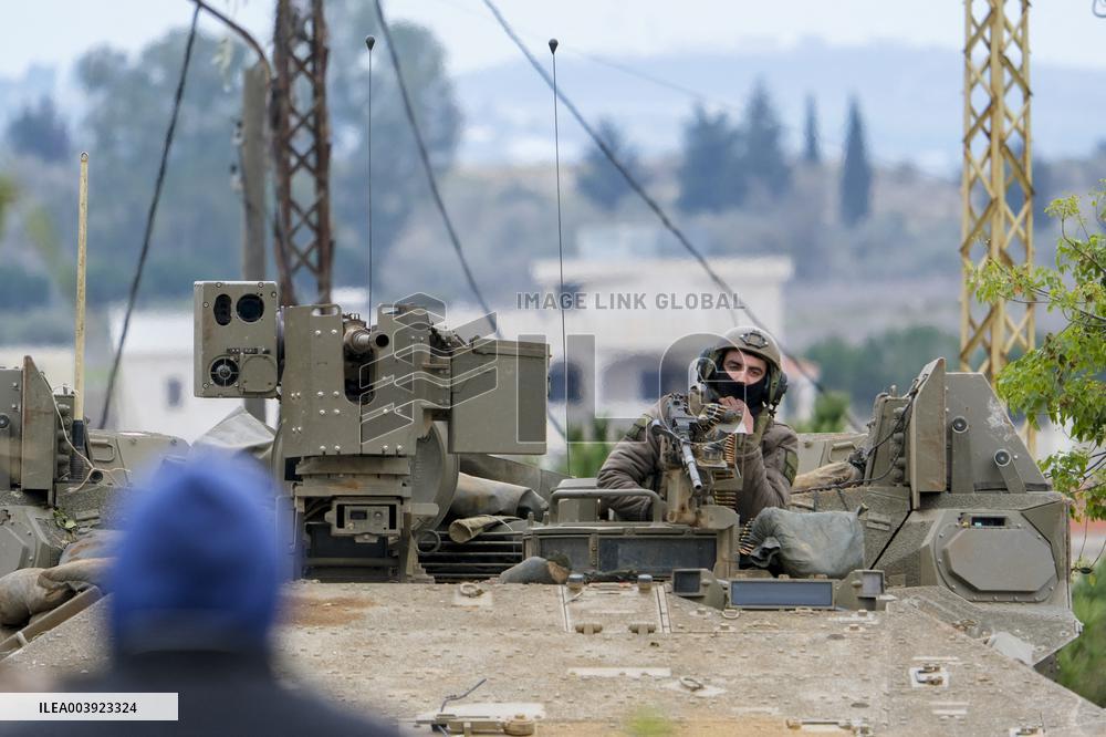 Israeli Soldiers Gather Behind Rubble In A Southern Lebanese Village