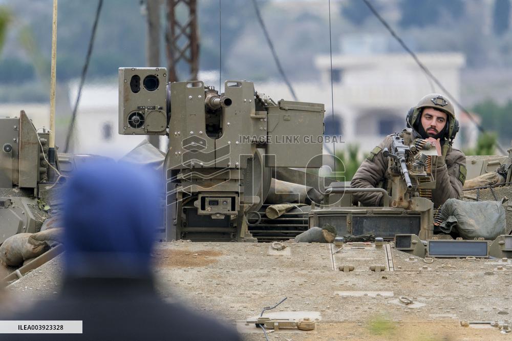 Israeli Soldiers Gather Behind Rubble In A Southern Lebanese Village