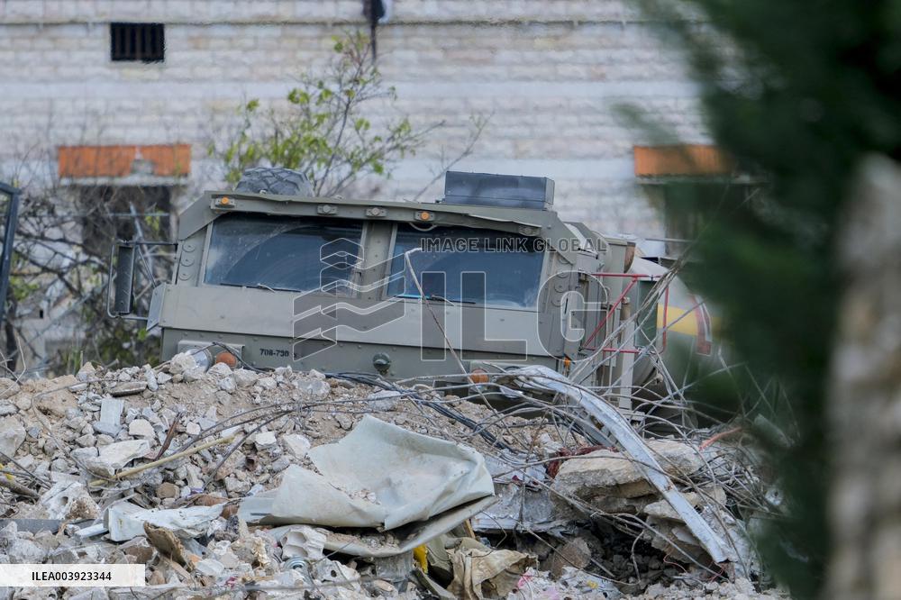 Israeli Soldiers Gather Behind Rubble In A Southern Lebanese Village