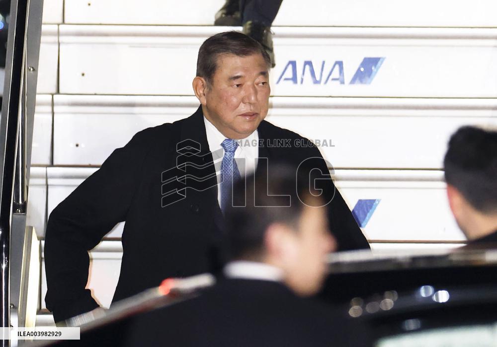 Japan PM Ishiba returns home