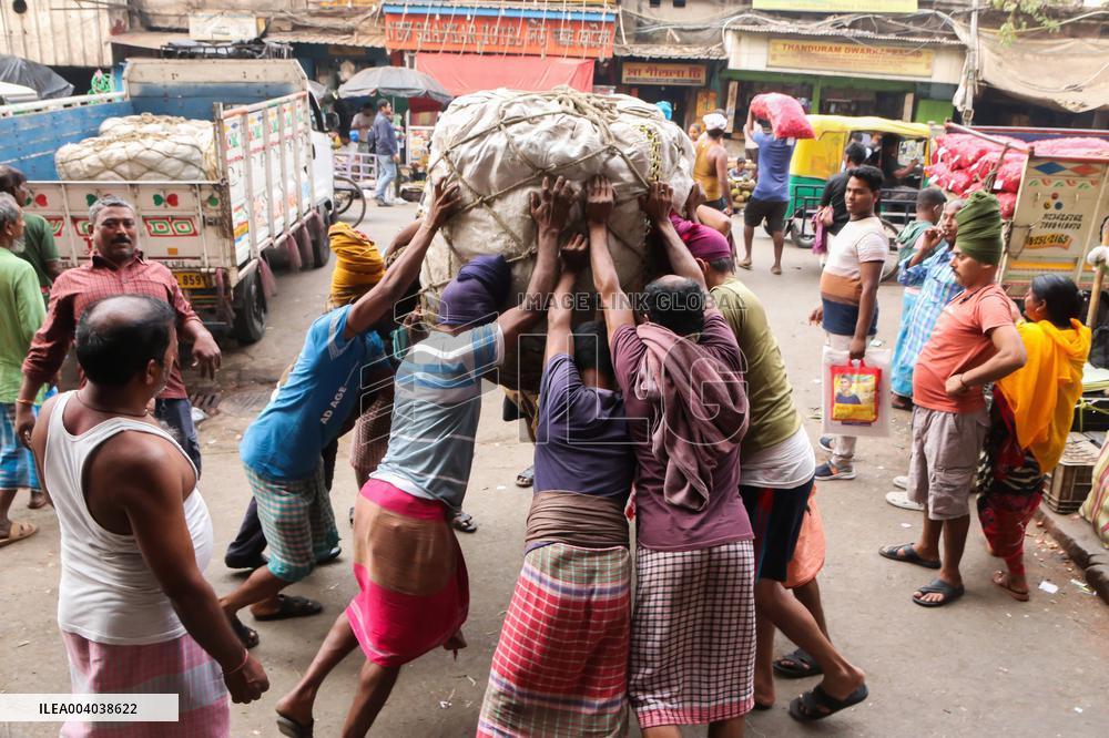 Labourers Unloading Vegetables Bags - India