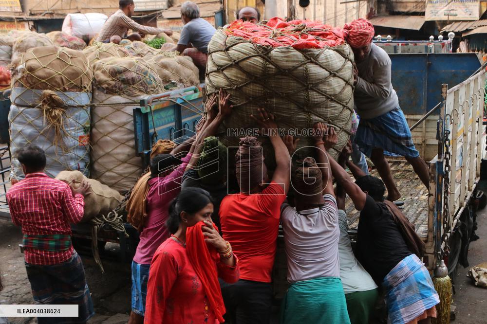 Labourers Unloading Vegetables Bags - India