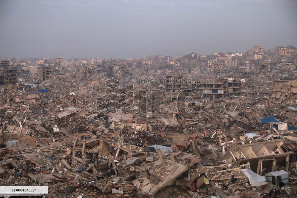 Displaced Palestinians Wait for Aid Amid the Rubble of Gaza’s Destruction