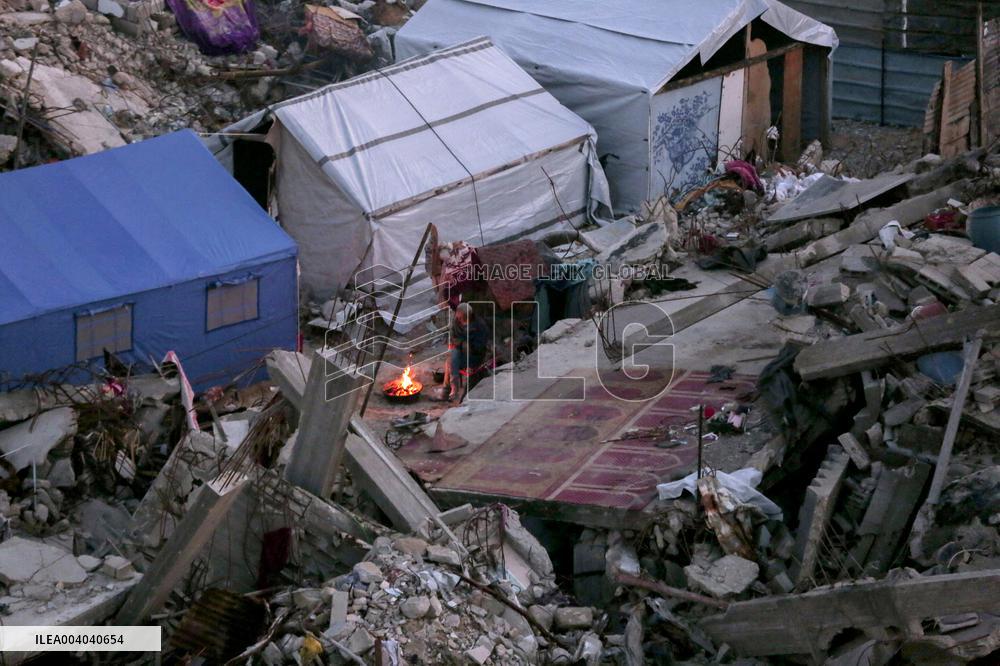 Displaced Palestinians Wait for Aid Amid the Rubble of Gaza’s Destruction