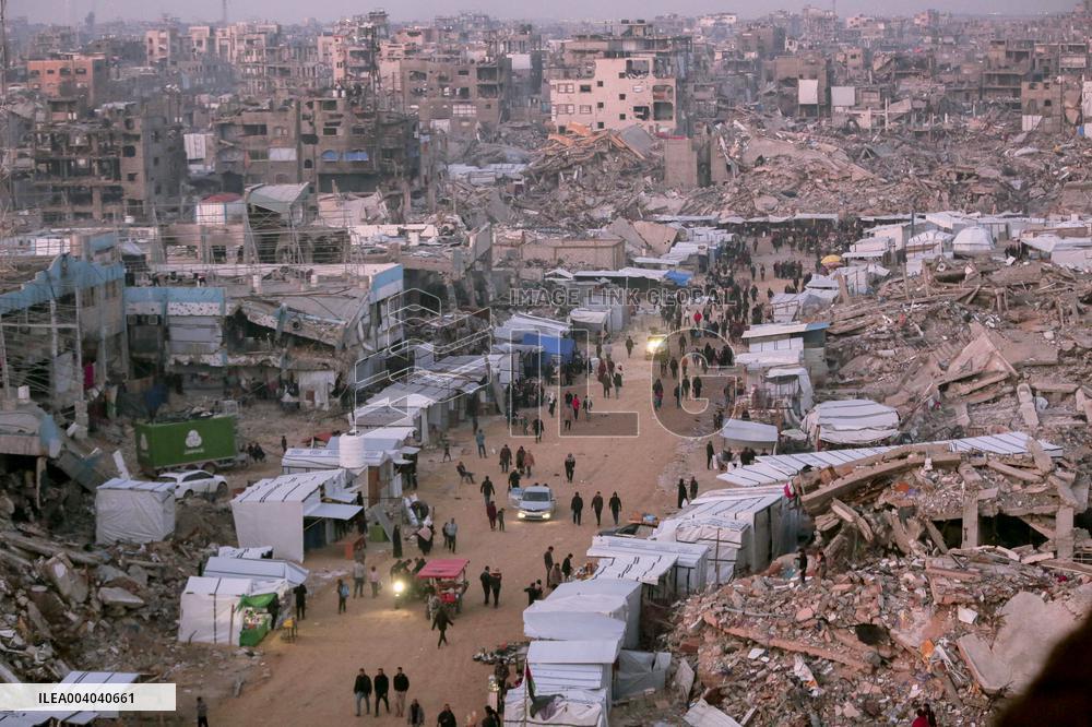 Displaced Palestinians Wait for Aid Amid the Rubble of Gaza’s Destruction