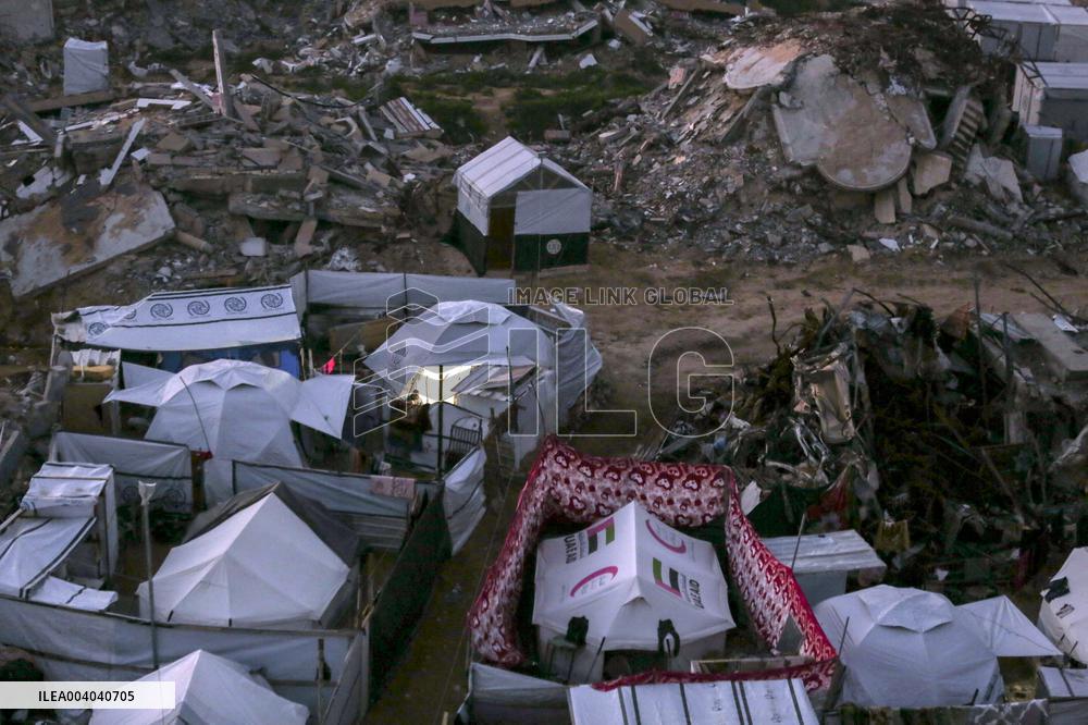 Displaced Palestinians Wait for Aid Amid the Rubble of Gaza’s Destruction