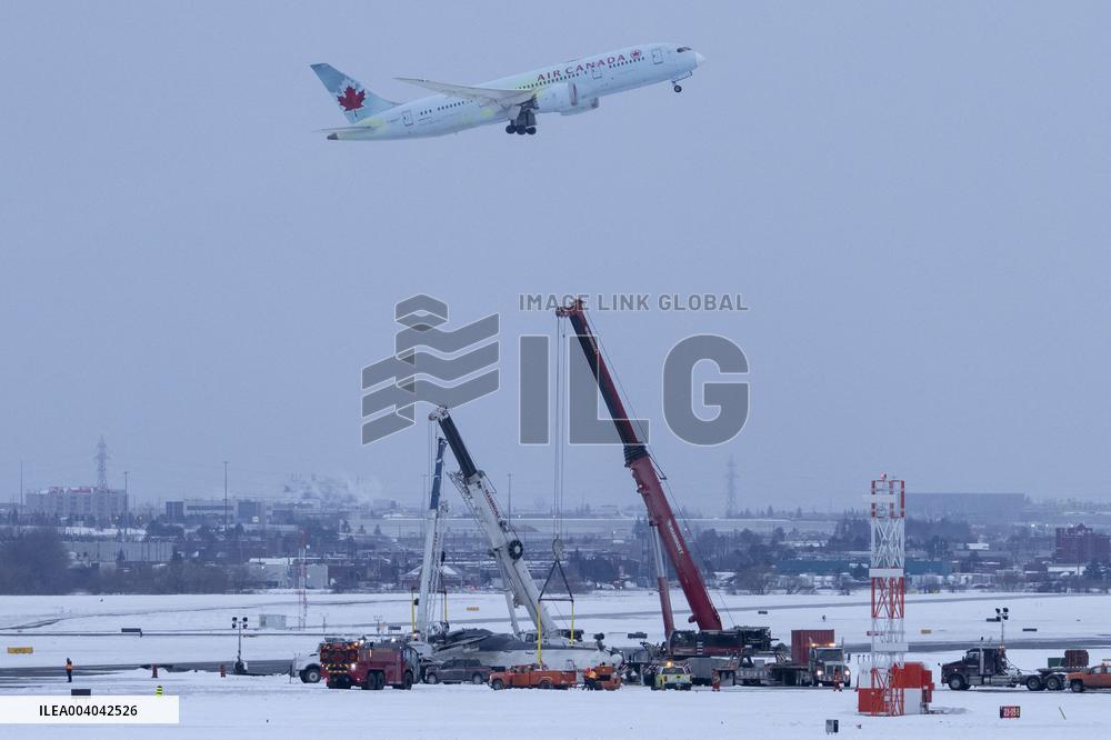 Cranes Lift Wreckage of Overturned Plane - Toronto