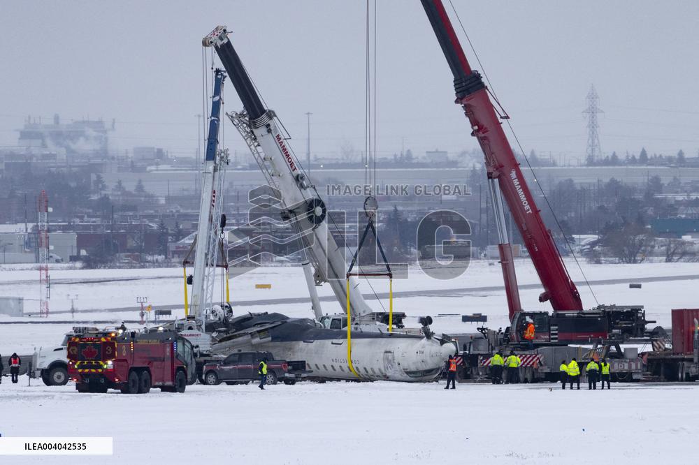 Cranes Lift Wreckage of Overturned Plane - Toronto