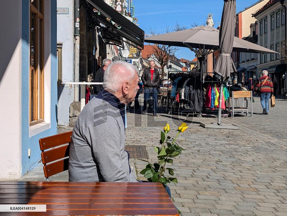 Elderly Man Holding Two Yellow Roses