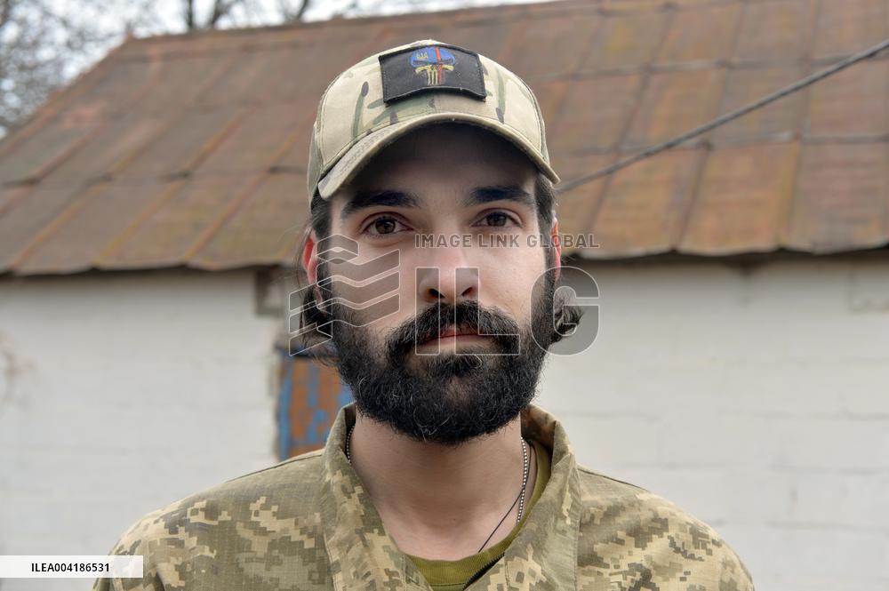 Serviceman of 57th Separate Motorized Brigade maintains American MK-19 grenade launcher