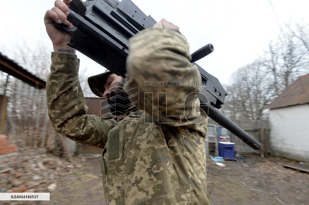 Serviceman of 57th Separate Motorized Brigade maintains American MK-19 grenade launcher