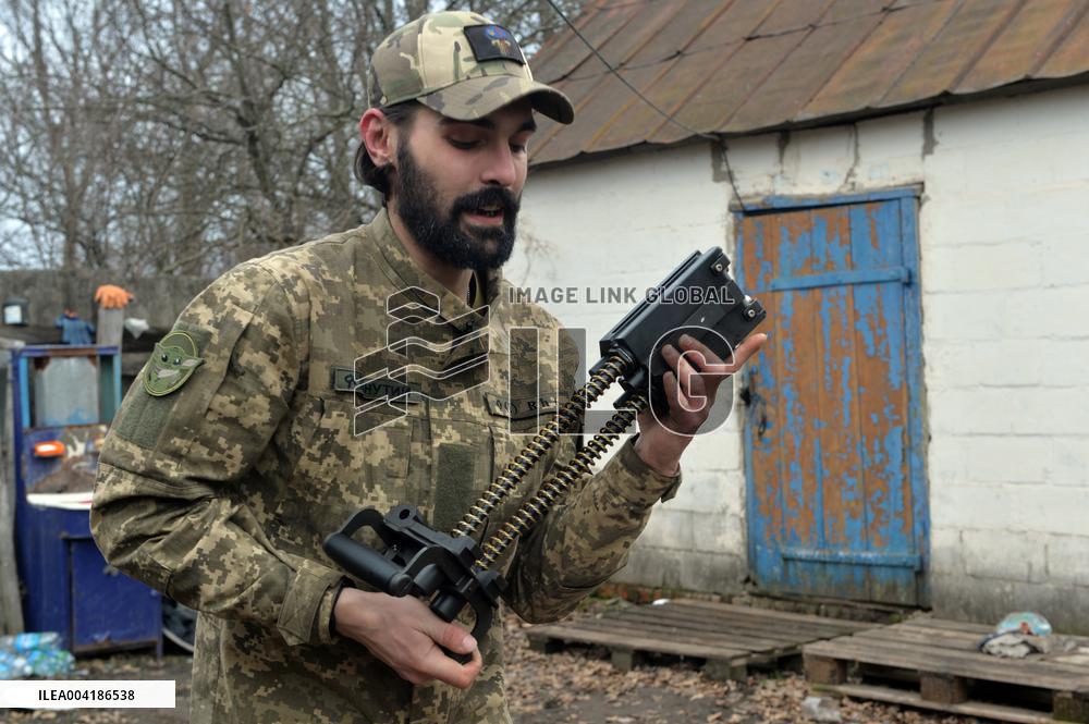 Serviceman of 57th Separate Motorized Brigade maintains American MK-19 grenade launcher