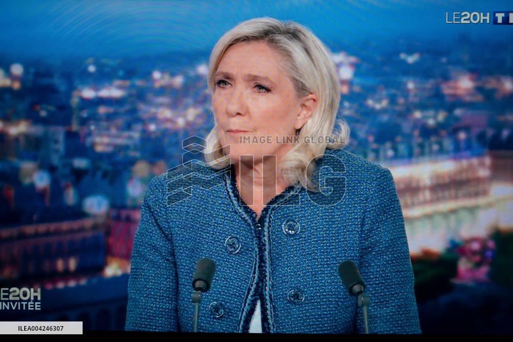 Marine Le Pen is seen on a monitor during a televised interview of TF1 - Paris AJ