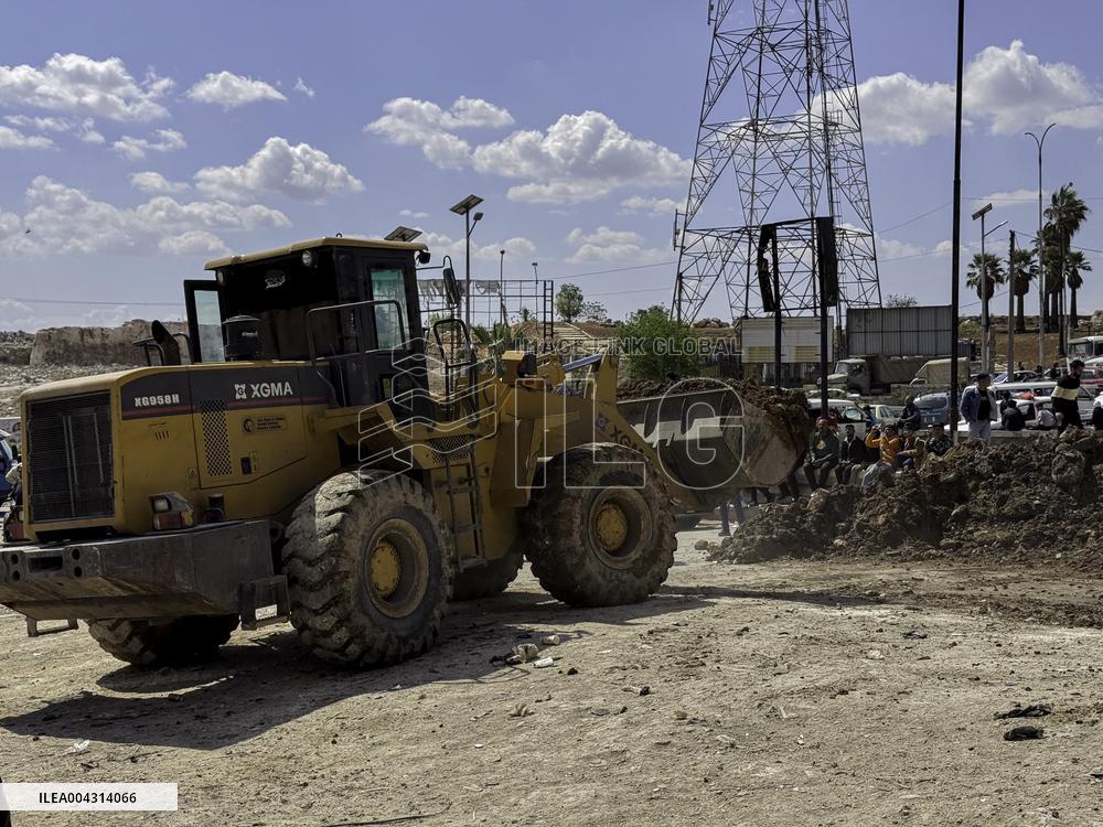Bulldozer Clears Aleppo Road Under New Agreement