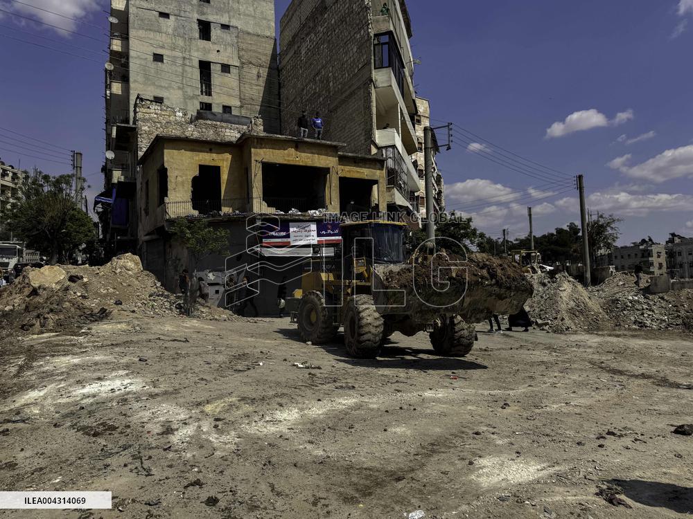 Bulldozer Clears Aleppo Road Under New Agreement