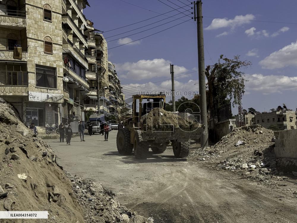 Bulldozer Clears Aleppo Road Under New Agreement