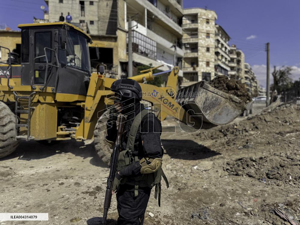 Bulldozer Clears Aleppo Road Under New Agreement
