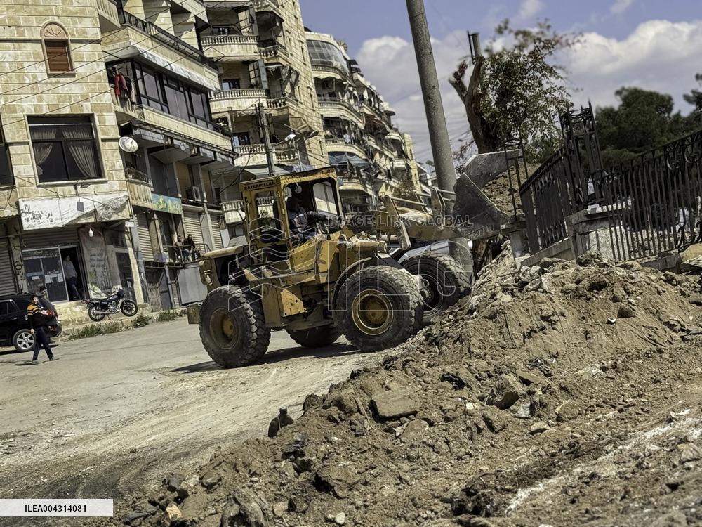 Bulldozer Clears Aleppo Road Under New Agreement