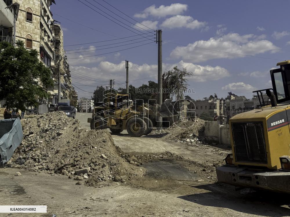 Bulldozer Clears Aleppo Road Under New Agreement