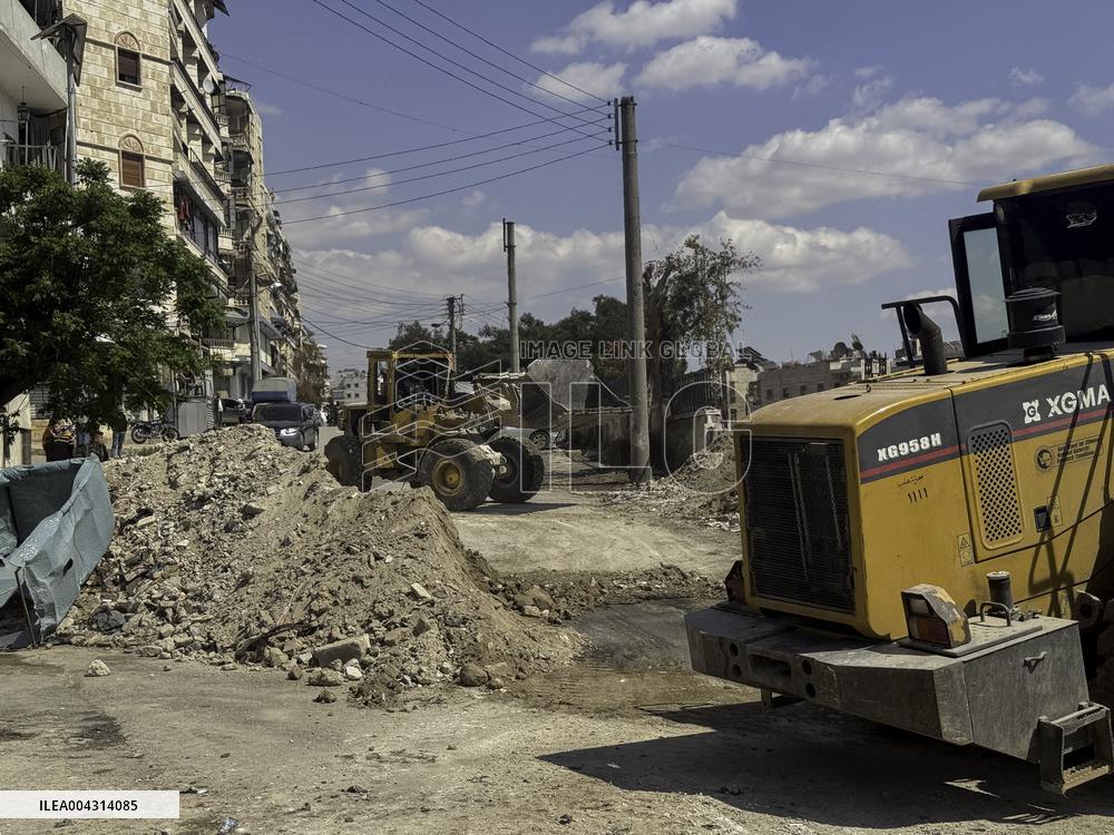 Bulldozer Clears Aleppo Road Under New Agreement