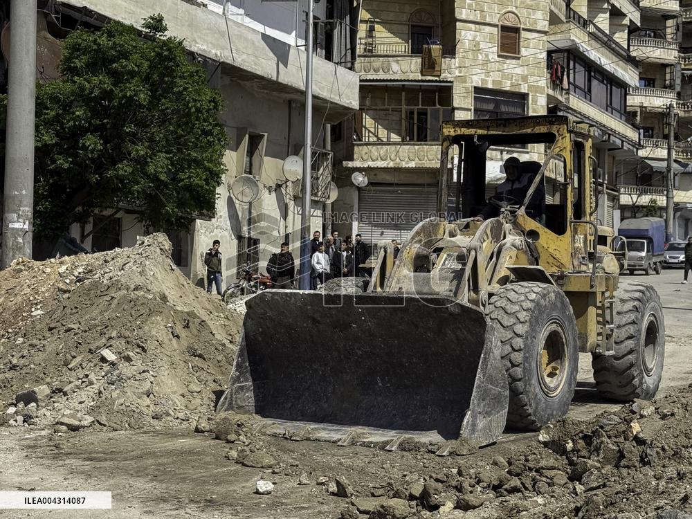 Bulldozer Clears Aleppo Road Under New Agreement