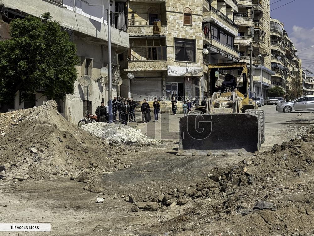 Bulldozer Clears Aleppo Road Under New Agreement