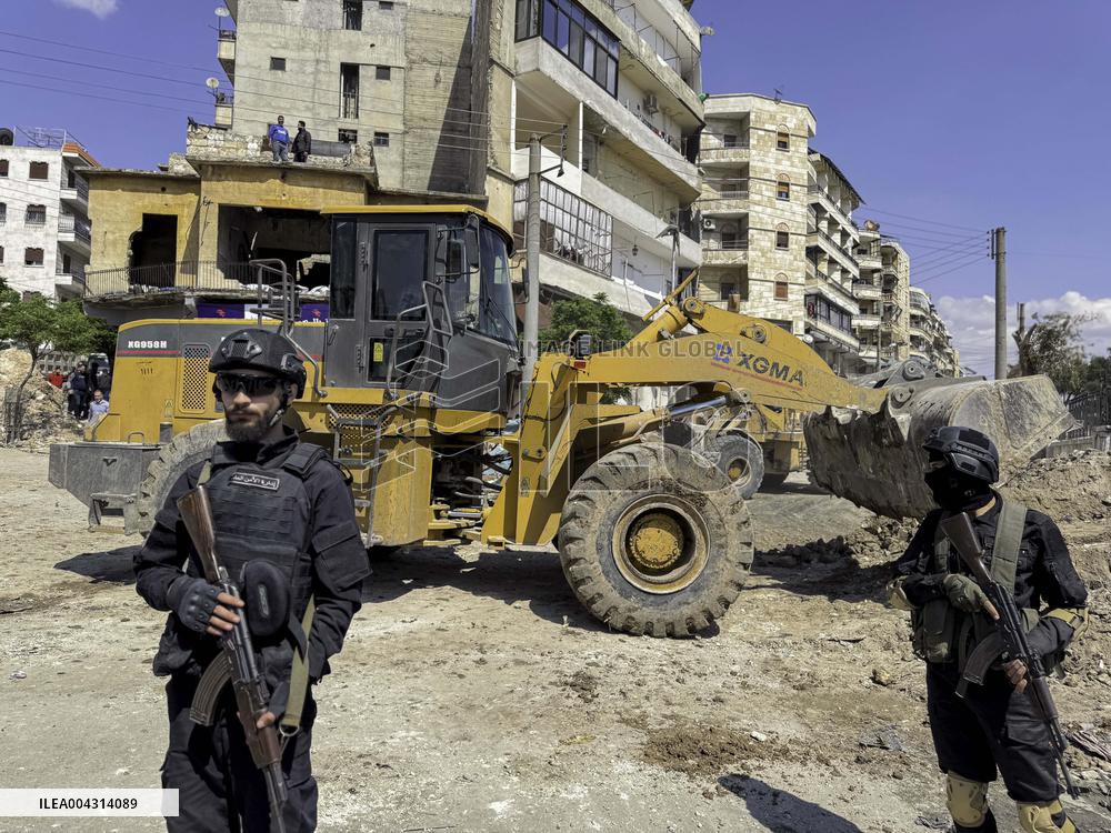 Bulldozer Clears Aleppo Road Under New Agreement
