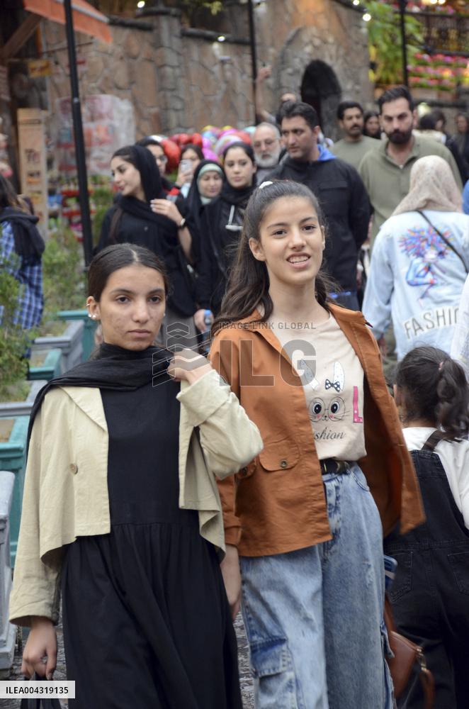 Iranian women defy the strict hijab laws in the street of Tehran