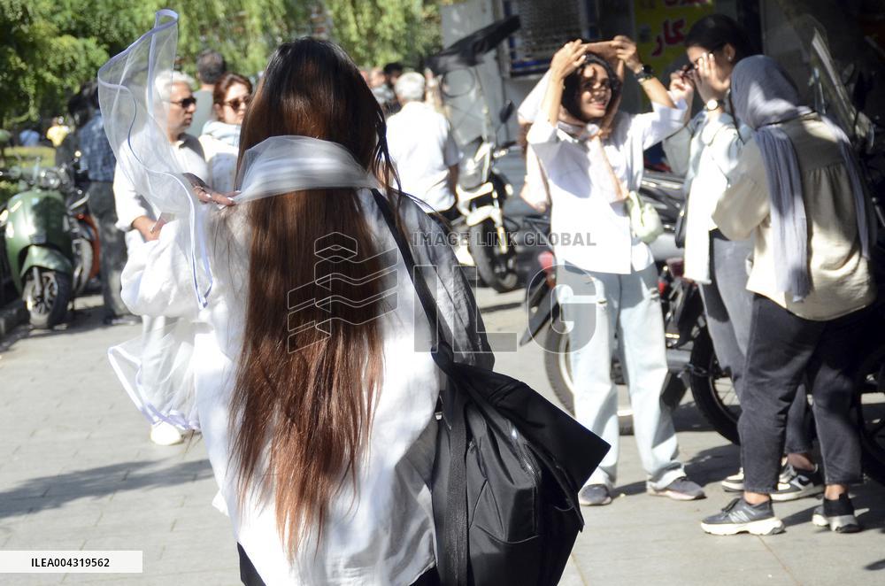 Iranian women defy the strict hijab laws in the street of Tehran
