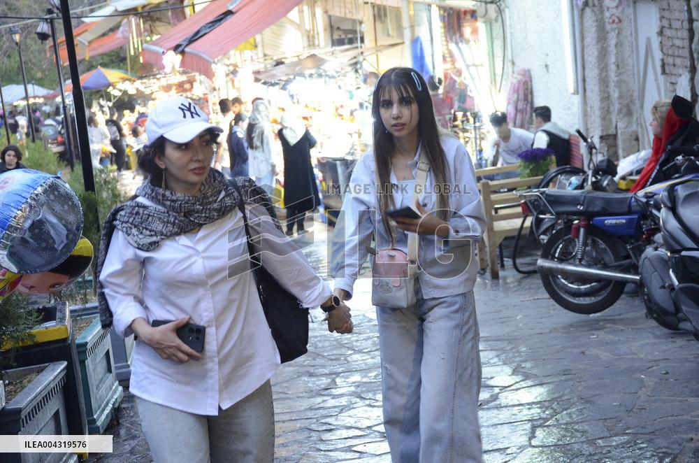 Iranian women defy the strict hijab laws in the street of Tehran