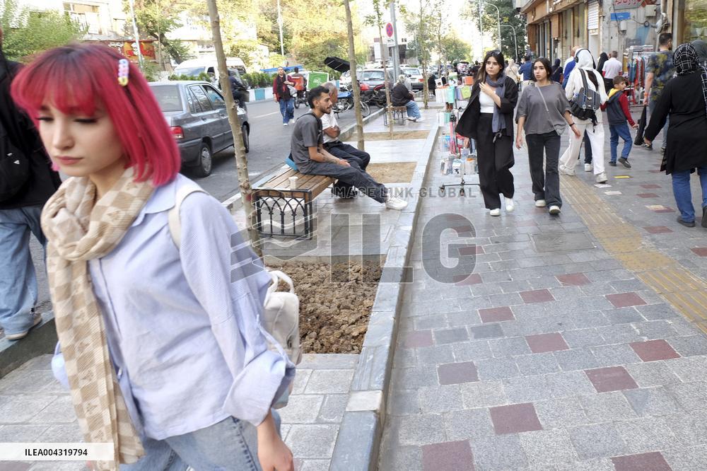Iranian women defy the strict hijab laws in the street of Tehran