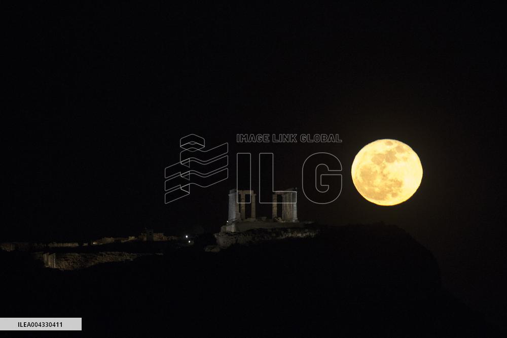 A Full Moon Rises Above The Ancient Temple Of Poseidon - Greece
