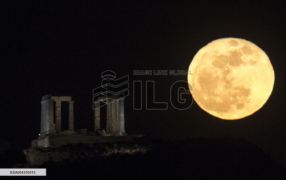 A Full Moon Rises Above The Ancient Temple Of Poseidon - Greece