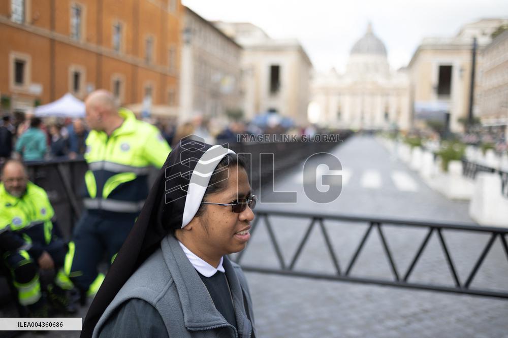 People queue at St Peter Basilica to pay their respects to late Pope Francis - Rome