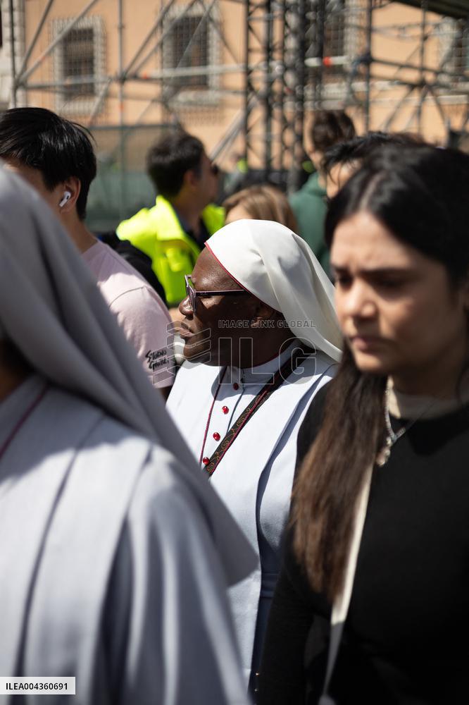 People queue at St Peter Basilica to pay their respects to late Pope Francis - Rome