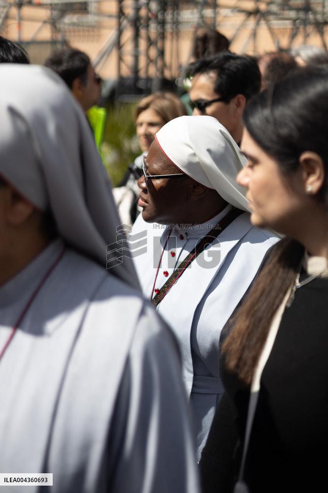 People queue at St Peter Basilica to pay their respects to late Pope Francis - Rome