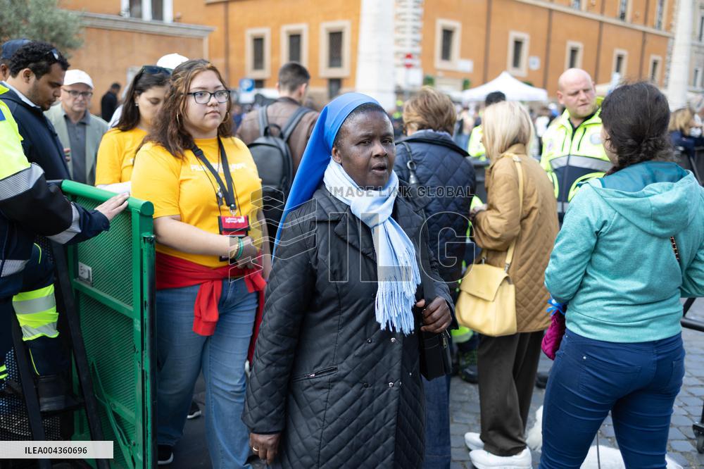 People queue at St Peter Basilica to pay their respects to late Pope Francis - Rome