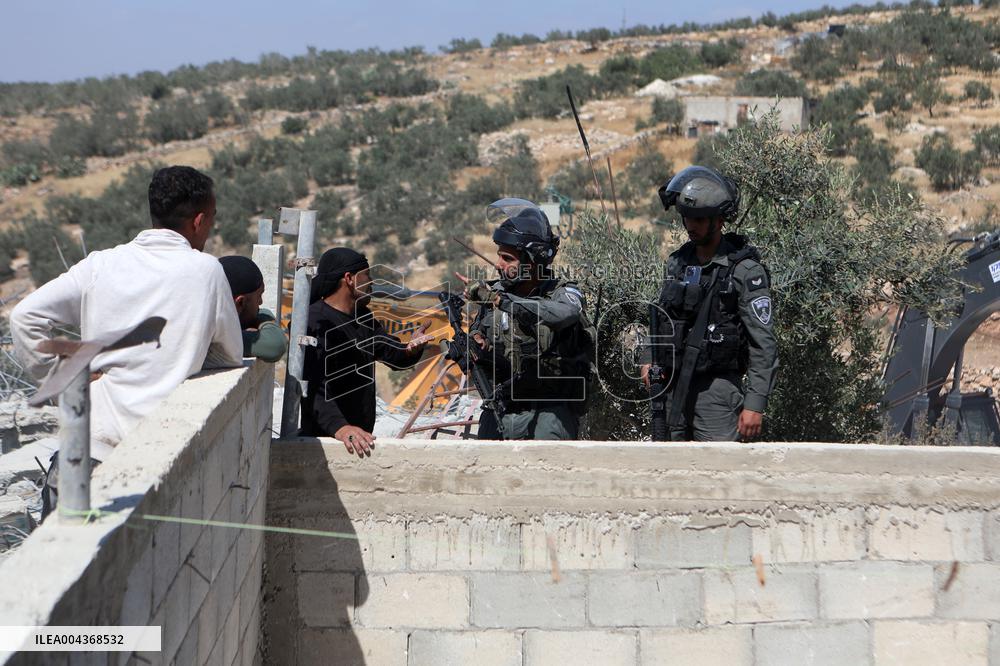 Israeli excavators demolish the houses in Hebron