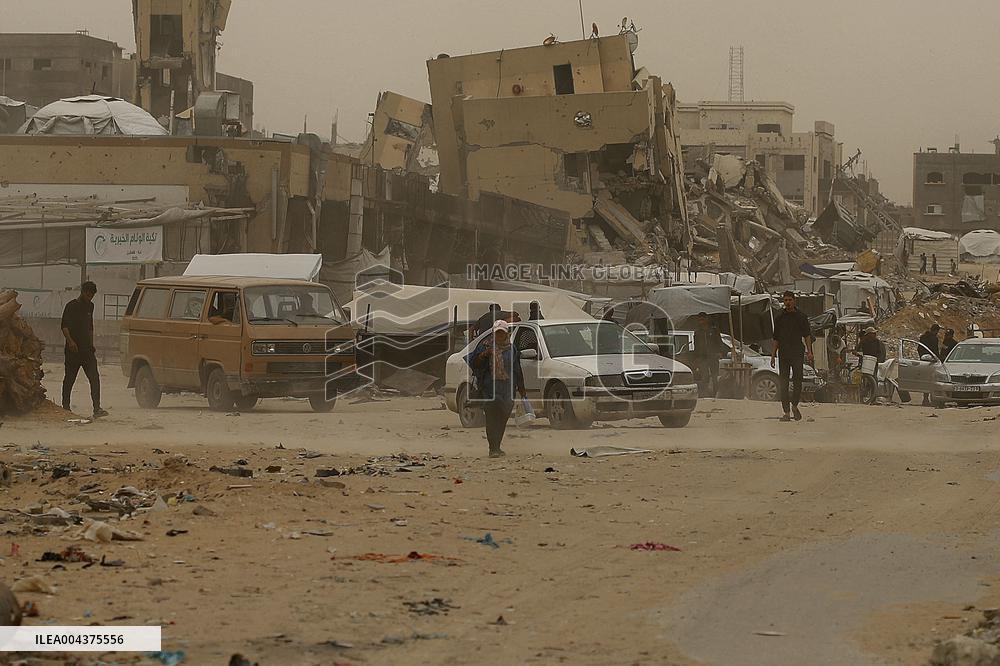 Palestinians Walking In A Sandstorm - Gaza