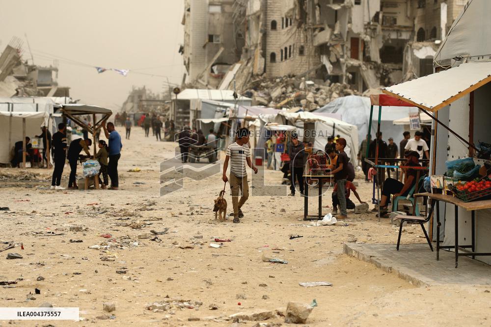 Palestinians Walking In A Sandstorm - Gaza
