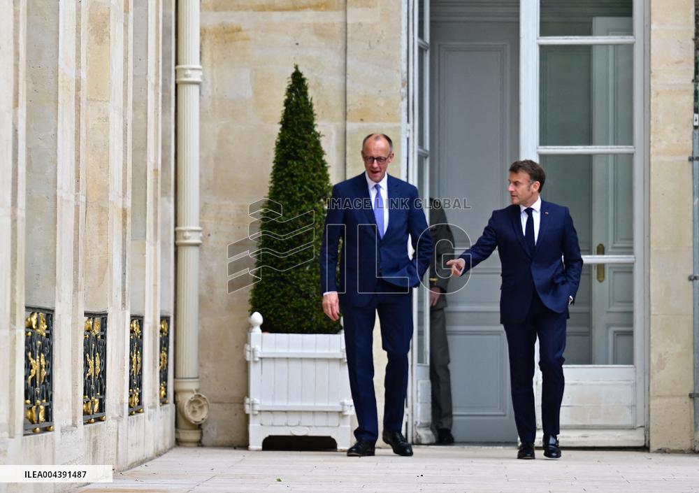 Macron and Merz Discuss in Elysee Garden - Paris