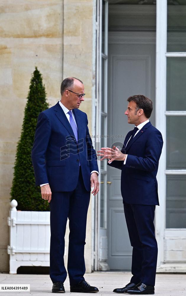 Macron and Merz Discuss in Elysee Garden - Paris