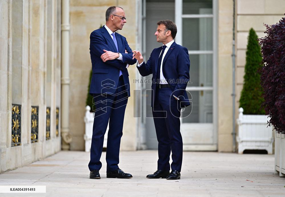 Macron and Merz Discuss in Elysee Garden - Paris