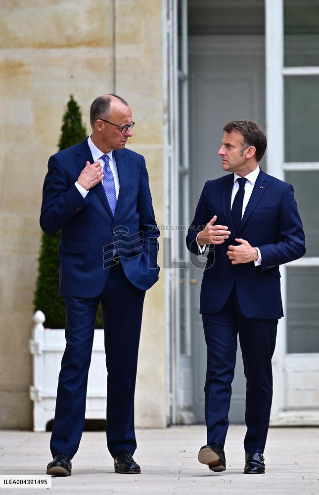 Macron and Merz Discuss in Elysee Garden - Paris