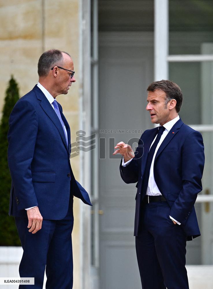 Macron and Merz Discuss in Elysee Garden - Paris
